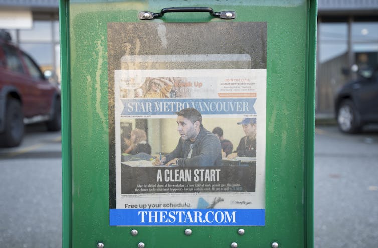 A newspaper in a newspaper box.